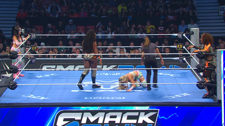 All four women inside and around the ring