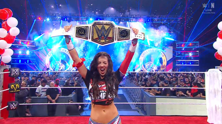 Green holding up her Interim Women's Championship belt