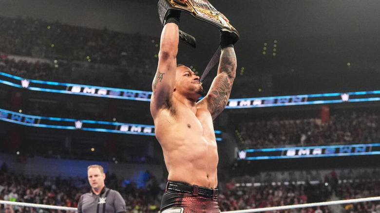 Carmelo Hayes hoists up his United States Championship.