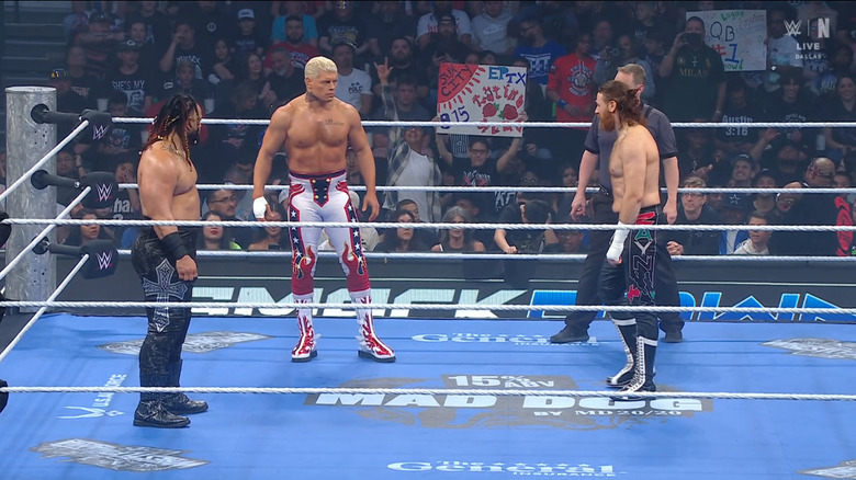 All three men staring one another down in the ring
