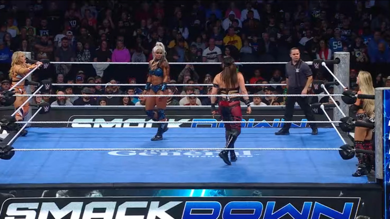 Cargill and Rodriguez staring one another down in the ring as Grace and Morgan stand on the apron