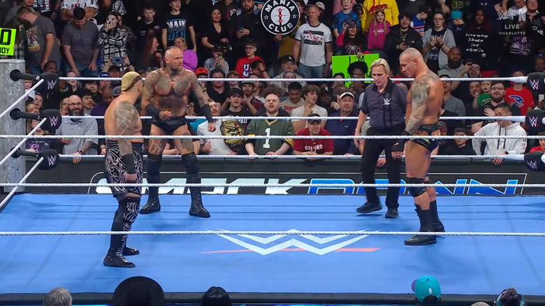 All three men in the ring staring one another down