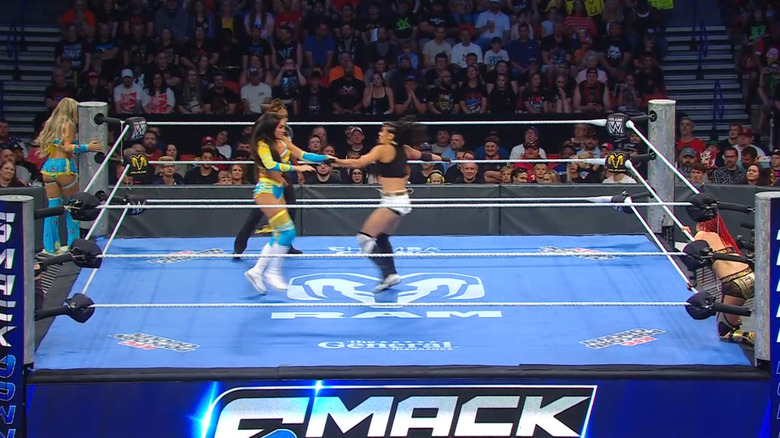 All four women inside and around the ring