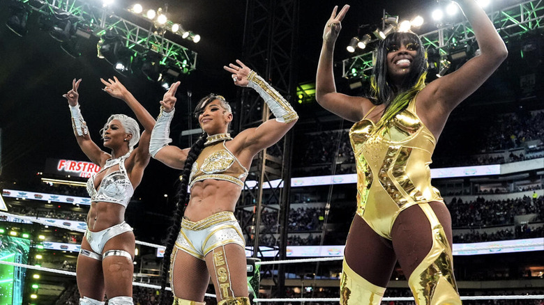 Cargill, Belair, and Naomi in the ring