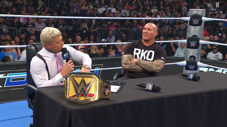 Rhodes and Orton sitting at the desk