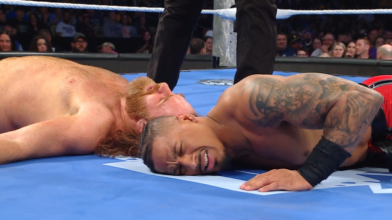 Hayes and Zayn both down in the ring
