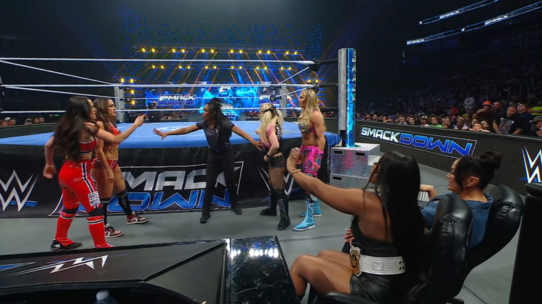 The Bella Twins and Flair and Bliss getting in one anothers faces as The Irresistible Forces watch on