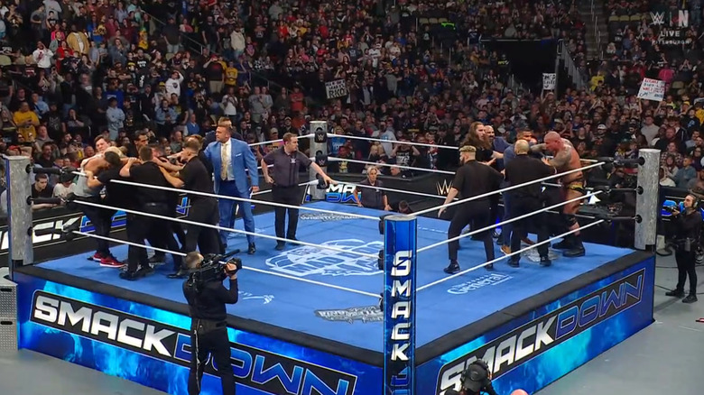 Both men being held back by security
