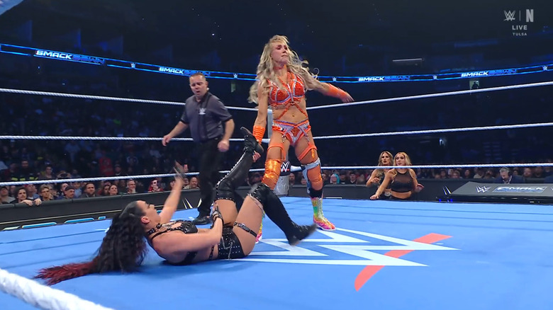 Flair looking to cinch in a Figure Eight Leg Lock on Jayne