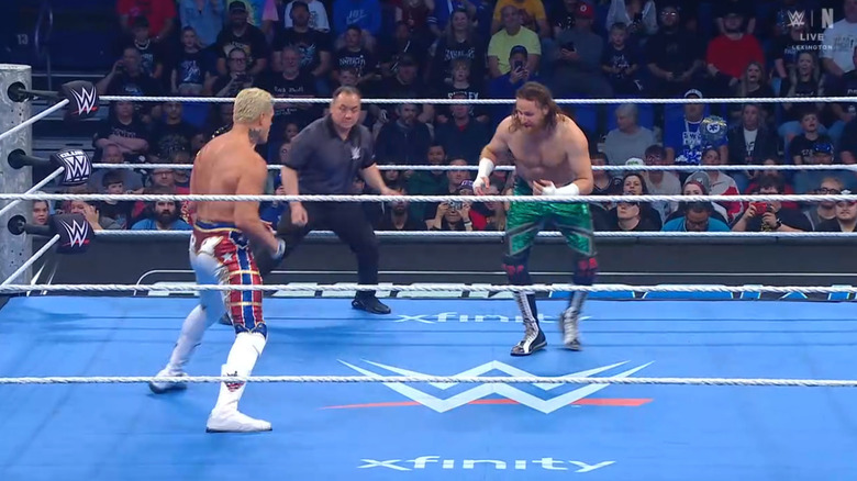 Rhodes and Zayn staring down one another in the ring