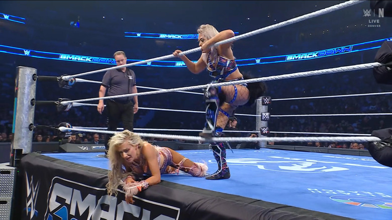 Giulia standing over Monroe