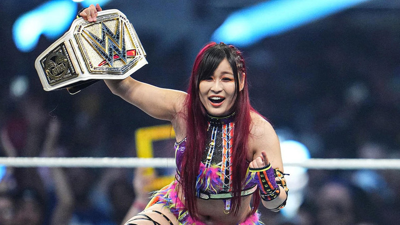 IYO SKY holding up the WWE Women's Championship