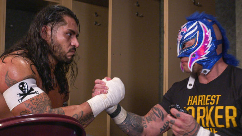 Rey Mysterio and Santos Escobar locking hands