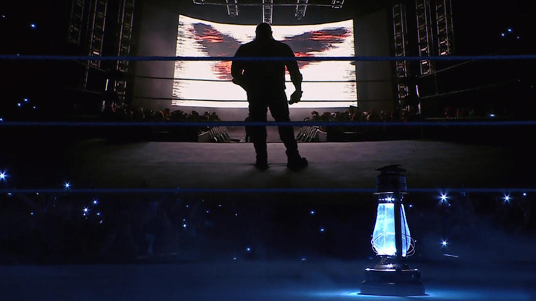 Bray Wyatt stands in silhouette for in tribute video