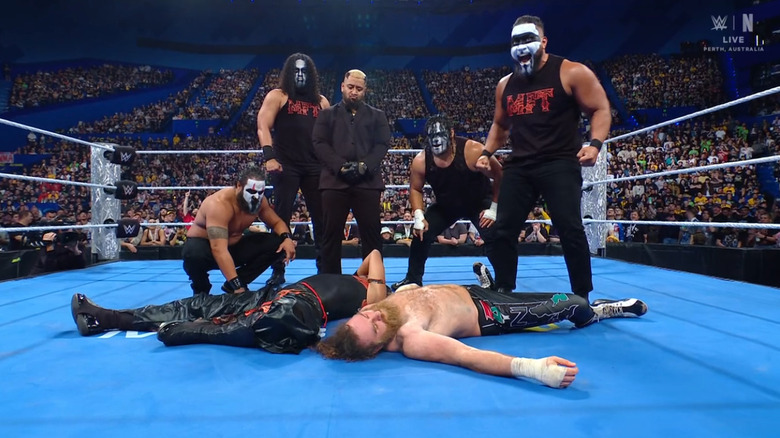 MFT standing over Zayn and Nakamura
