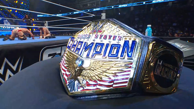 Dragunov and McDonagh in the ring as the United States Championship belt is shown
