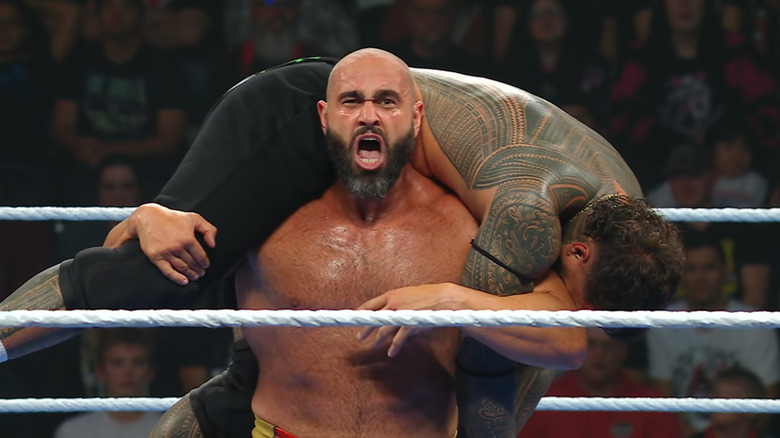 Rusev with Jey up on his shoulders