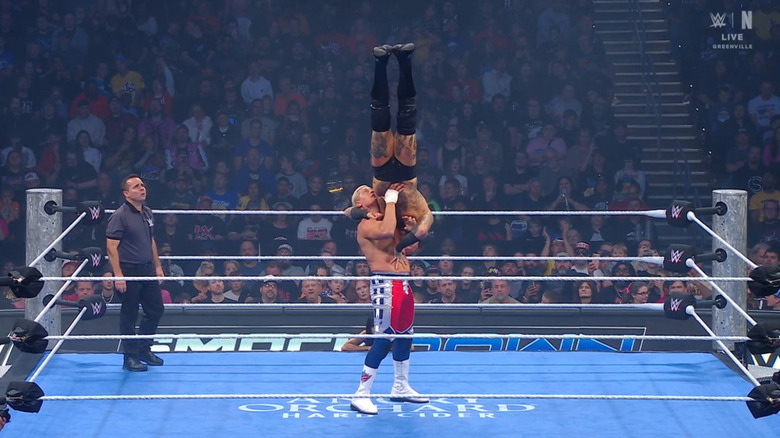 Rhodes with Black in a delayed vertical suplex position