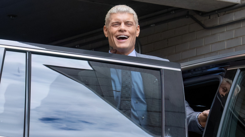 Rhodes about to exit a car