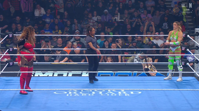 Jax and Flair staring one another down in the ring