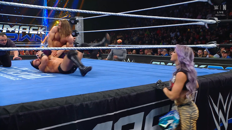 Frazer and Gargano in the ring as LeRae and Axiom watch from the outside