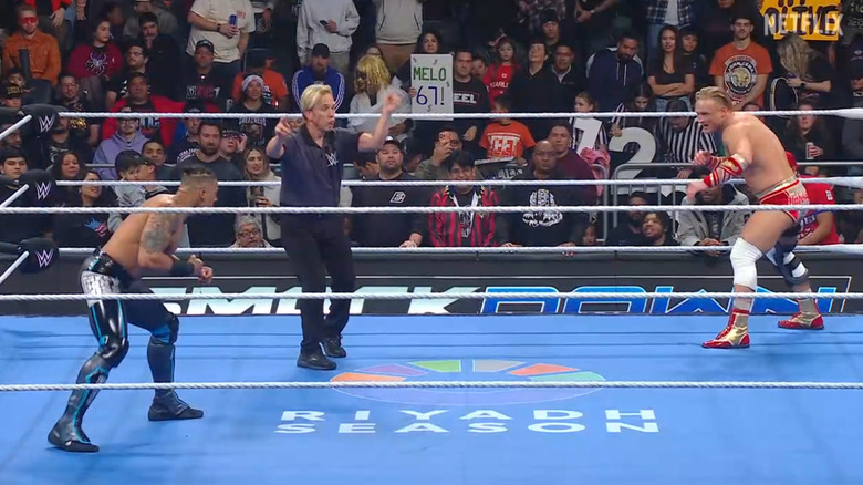 Dragunov and  Hayes staring one another down in the ring