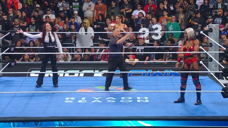 Fyre and Cargill staring one another down in the ring as Green stands on the apron