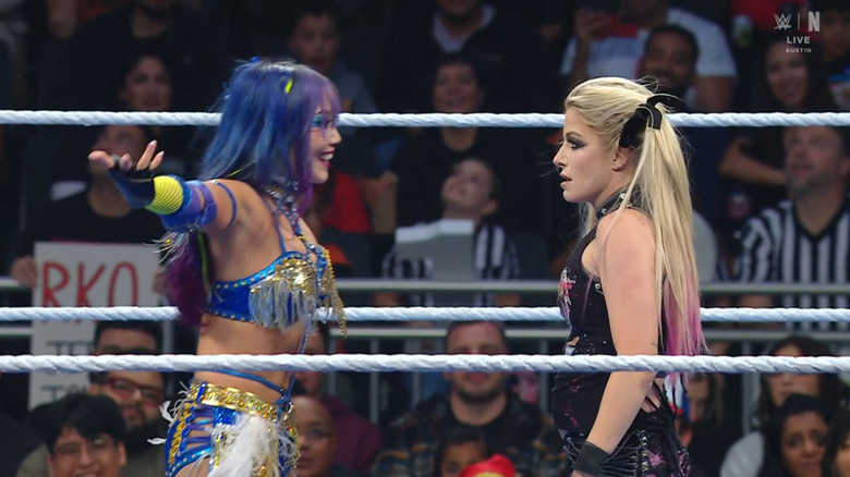 Sane and Bliss staring one another down in the ring