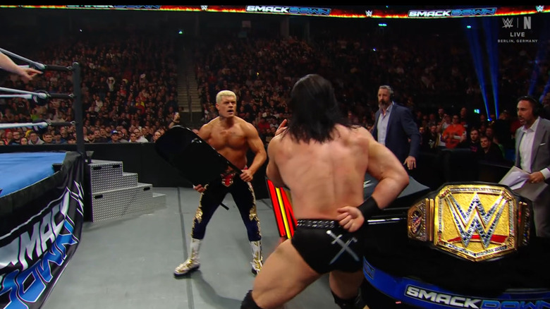 Rhodes holding a chair on the outside