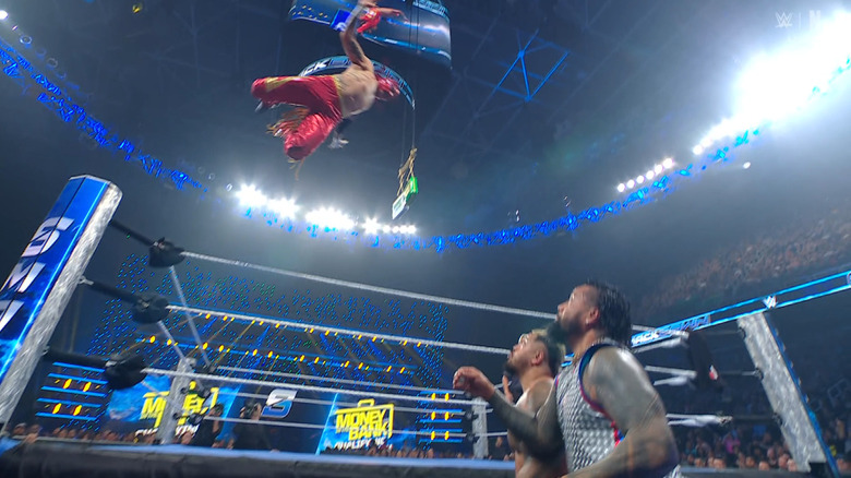 Rey flying to level Jimmy and Sikoa on the outside