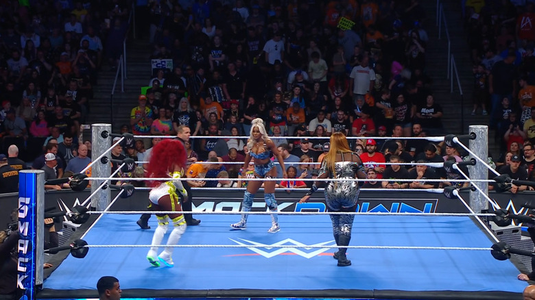 All three women in the ring about to lock up