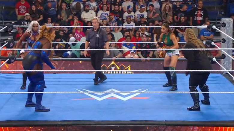 The four women inside the ring staring each other down