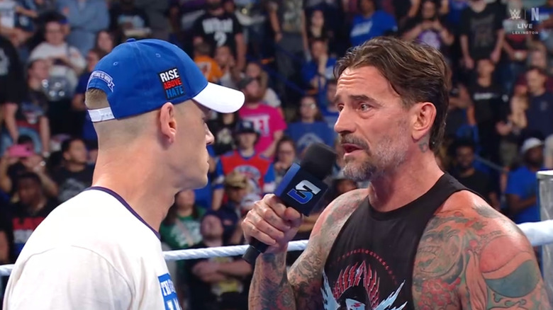 Cena and Punk staring each other down in the ring