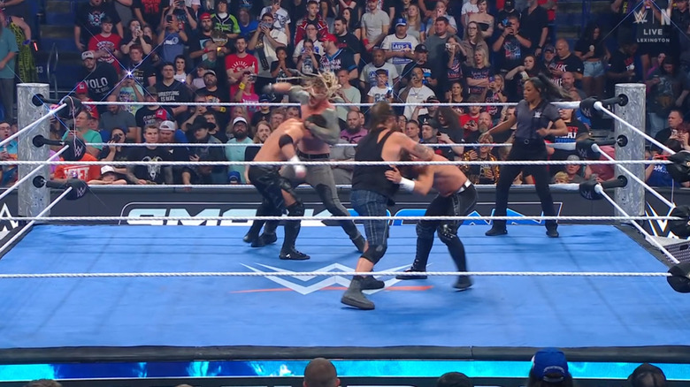 The four men brawling with one another in the ring