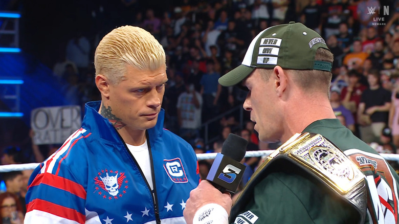 Rhodes and Cena talking with one another in the ring