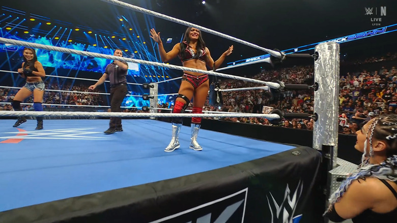Michin and James in the ring as Giulia watches from the outside