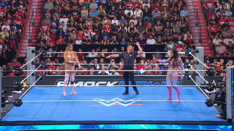 Flair and Green staring one another down in the ring