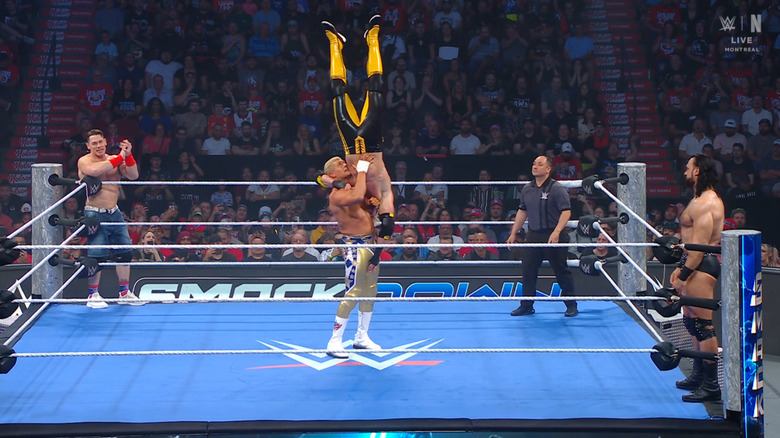 Rhodes with Paul in a delayed vertical suplex position