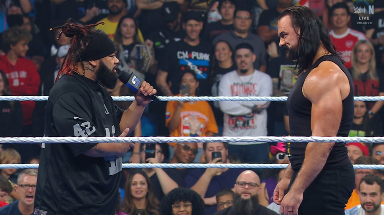 Fatu and McIntyre staring one another down in the ring