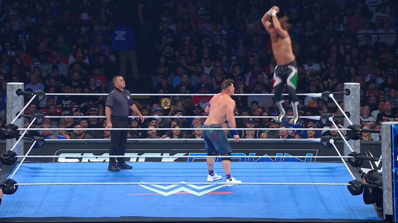 Zayn flying off the middle rope with the double ax handle