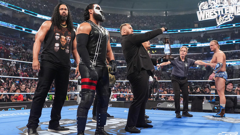 Solo Sikoa holding the lantern