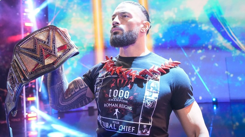 Roman Reigns shows off his title belt