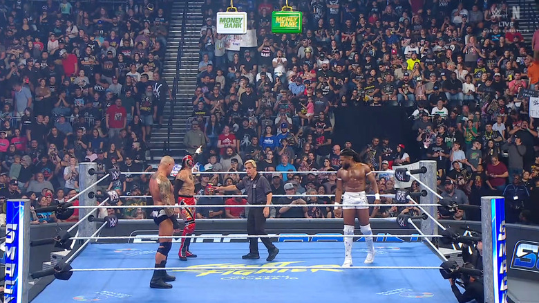 All three men standing inside the ring