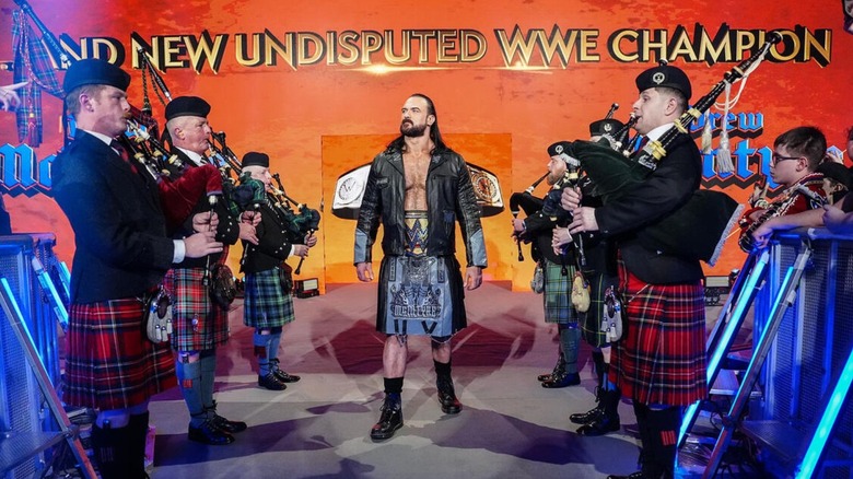 Undisputed WWE Champion Drew McIntyre makes his way down to the ring, a Scottish band playing bagpipes lining the ramp, on an episode of 