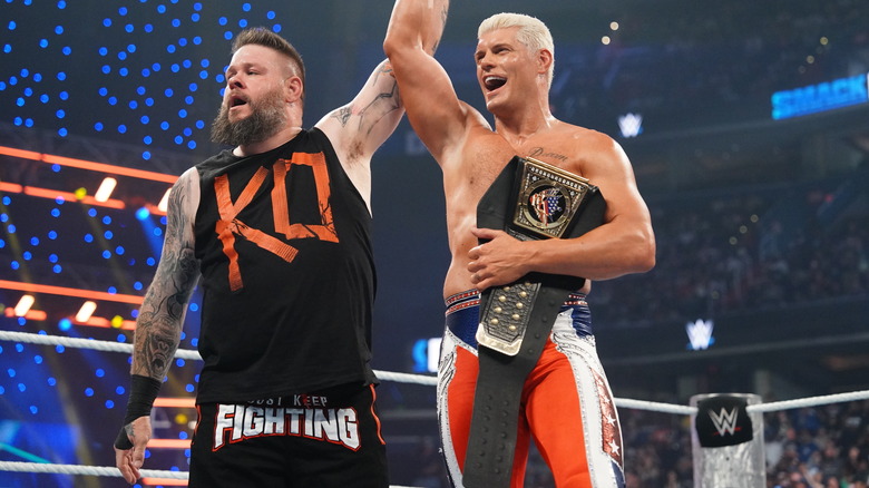 Kevin Owens raises Cody Rhodes' arm