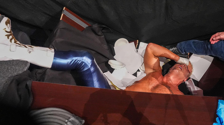 Cody Rhodes lays in a pile of debris