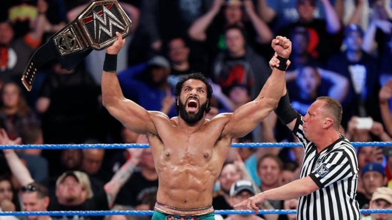 Jinder Mahal holds up the WWE Championship in the ring after a win.