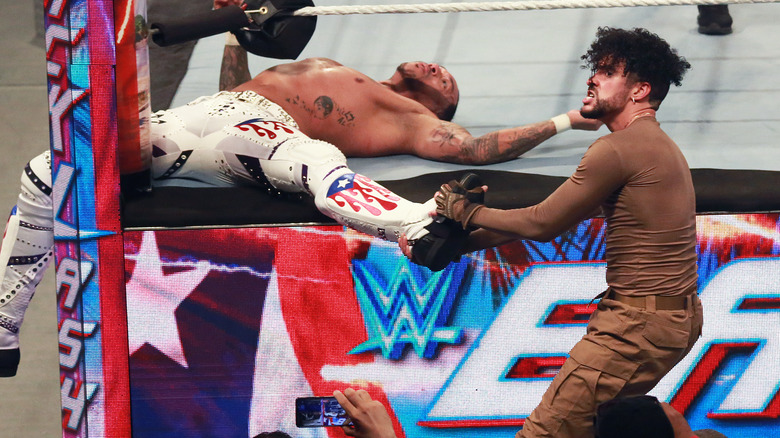 Bad Bunny prepares to do dastardly things to Damian Priest's leg