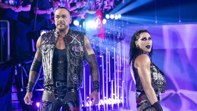 Rhea Ripley and Damian Priest make their entrance during Bash in Berlin
