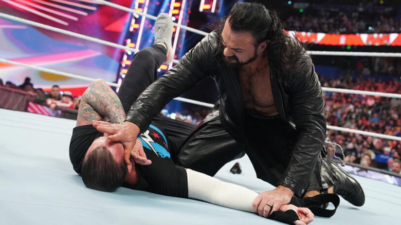 Drew McIntyre pushing CM Punk's face into the mat